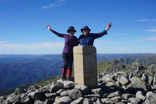 Emma and Trevor standing at the cairn at the summit of Mt Townsend