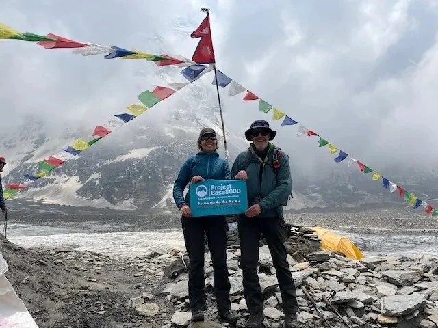 Project Base8000 at Dhaulagiri Base Camp in front of prayer flags