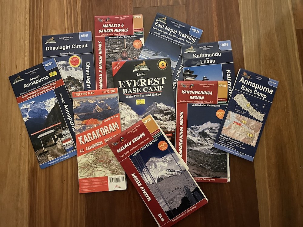 a pile of trekking maps