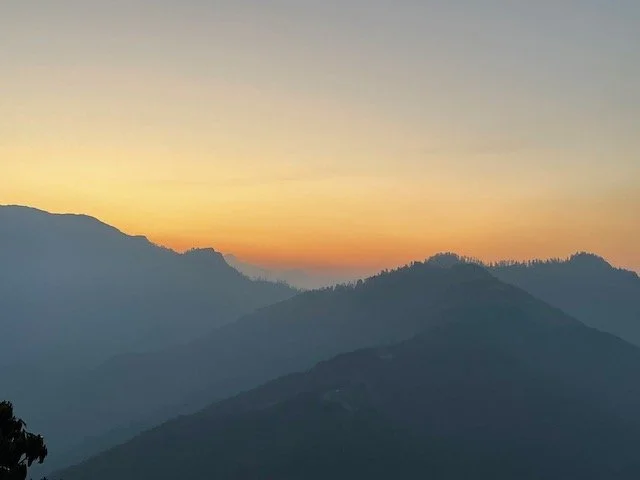 sunrise over mountains and hills at start of trek up to Poon Hill