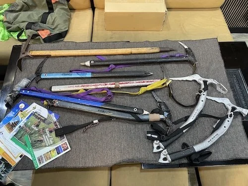 a collection of ice axes on a table