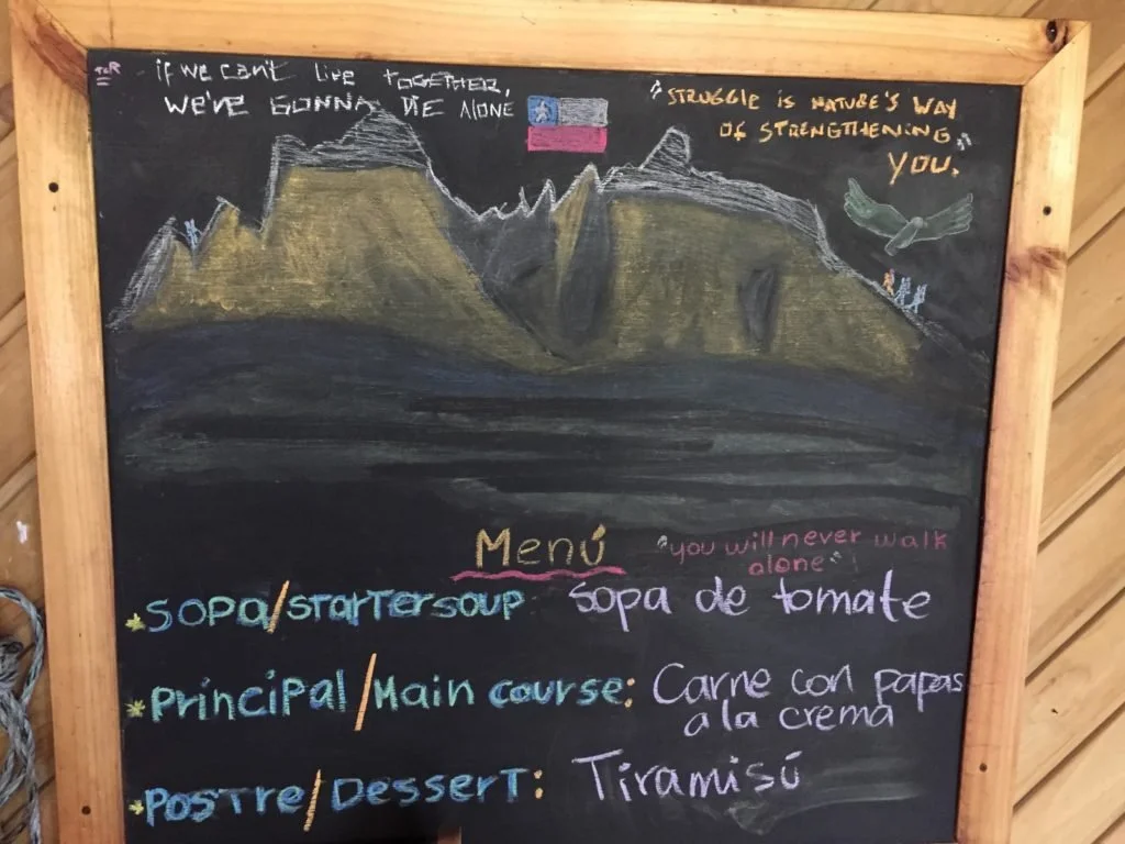 Refugio Menu on a blackboard with a drawing of the mountains