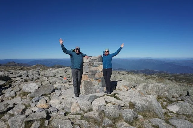 Emma and Trevor on Mt Kosciuszko Summit with perfect blue sky day
