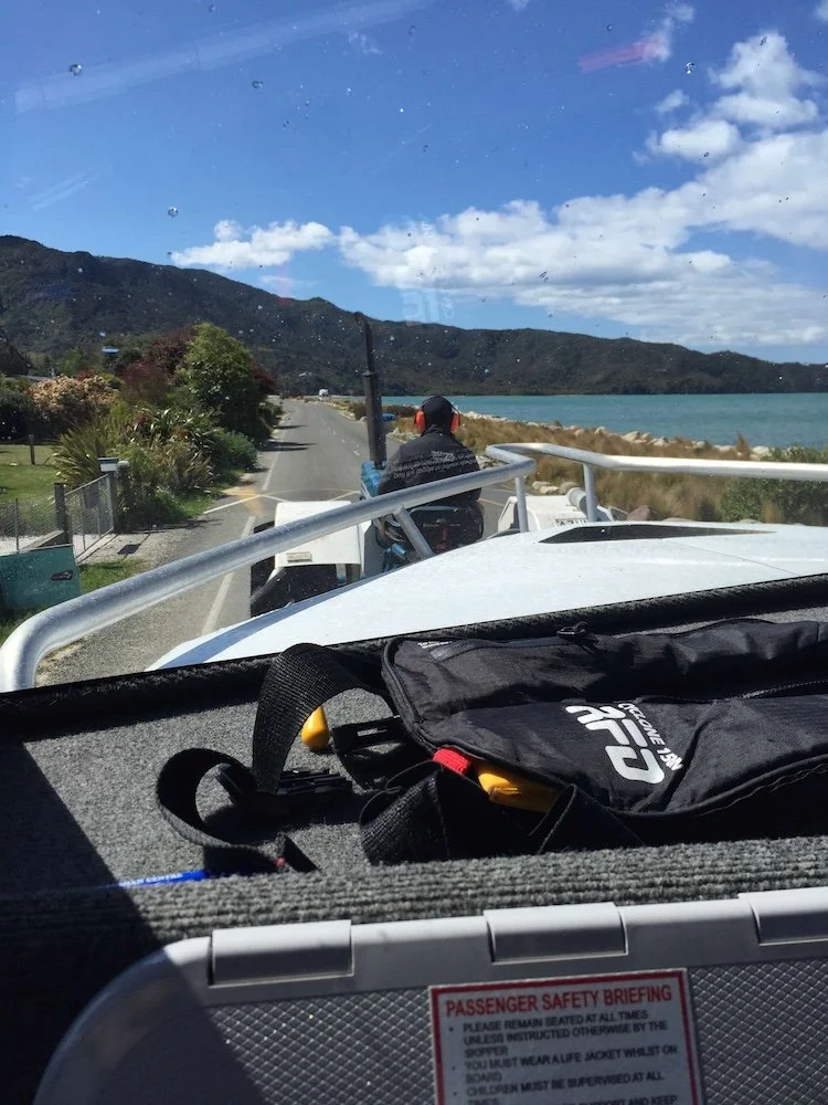 view from boat as its towed along a street by a tractor