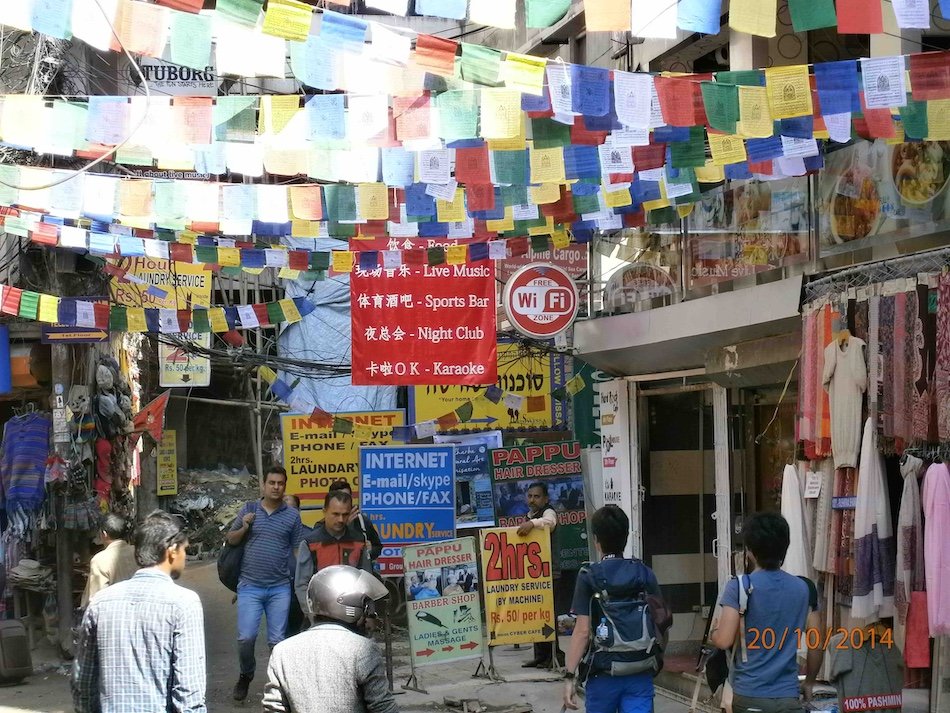 a busy street decorated with prayer flags in Thamel, Kathmandu
