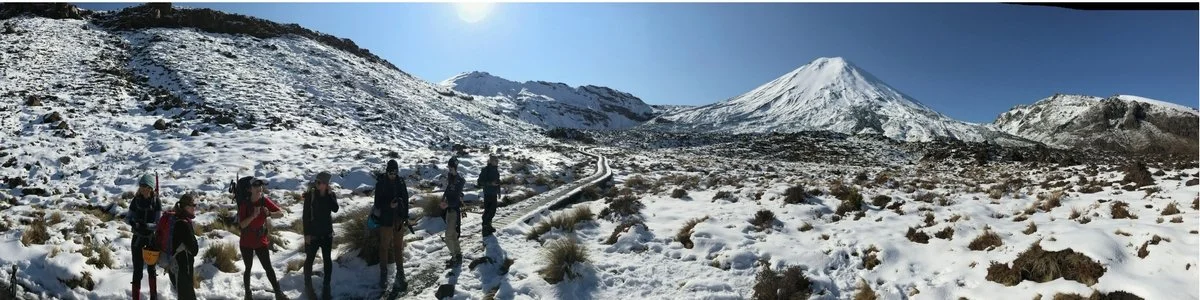 wide view of hikers with Mt Ngauruhoe in background