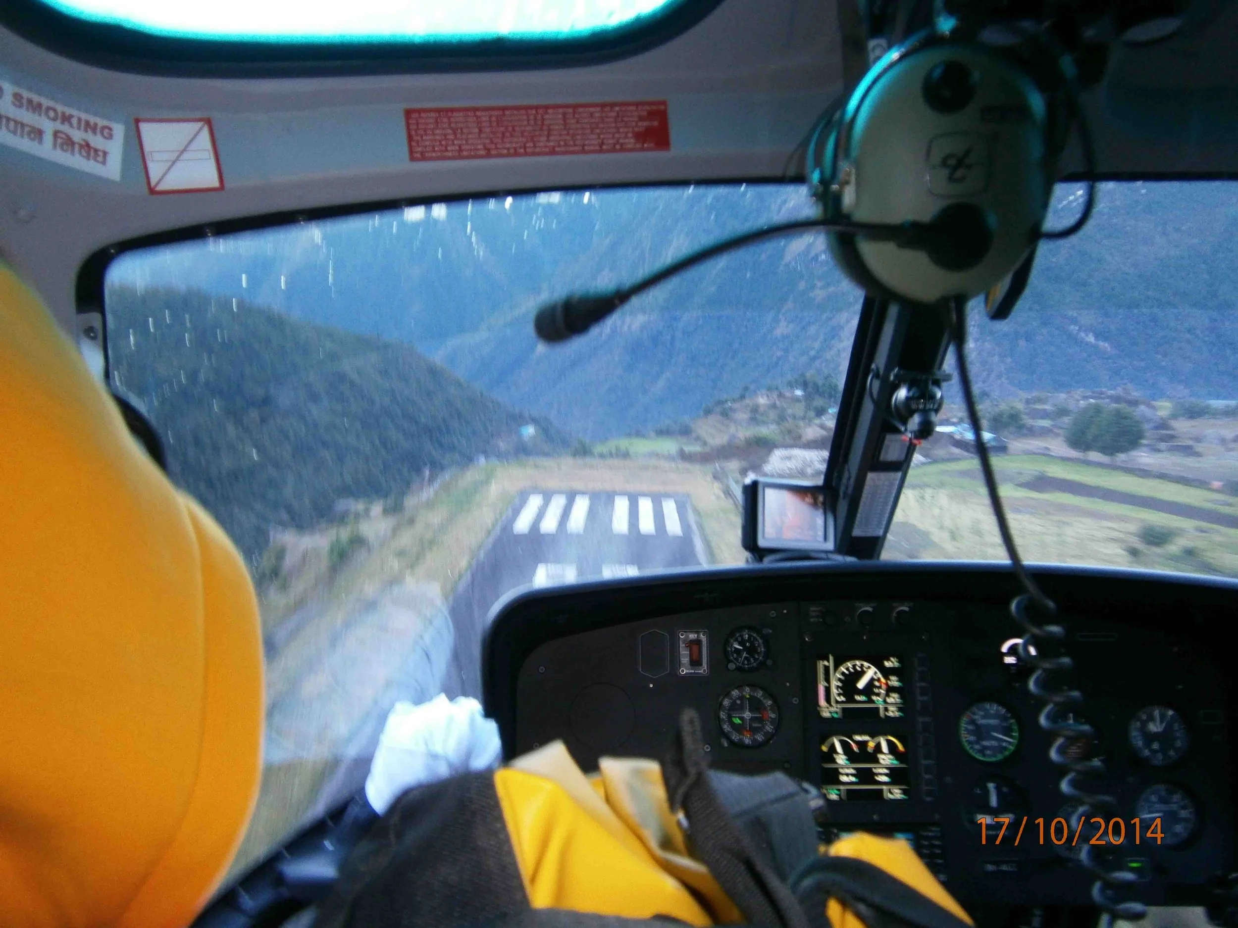 view from inside a helicopter taking off from Lukla airport