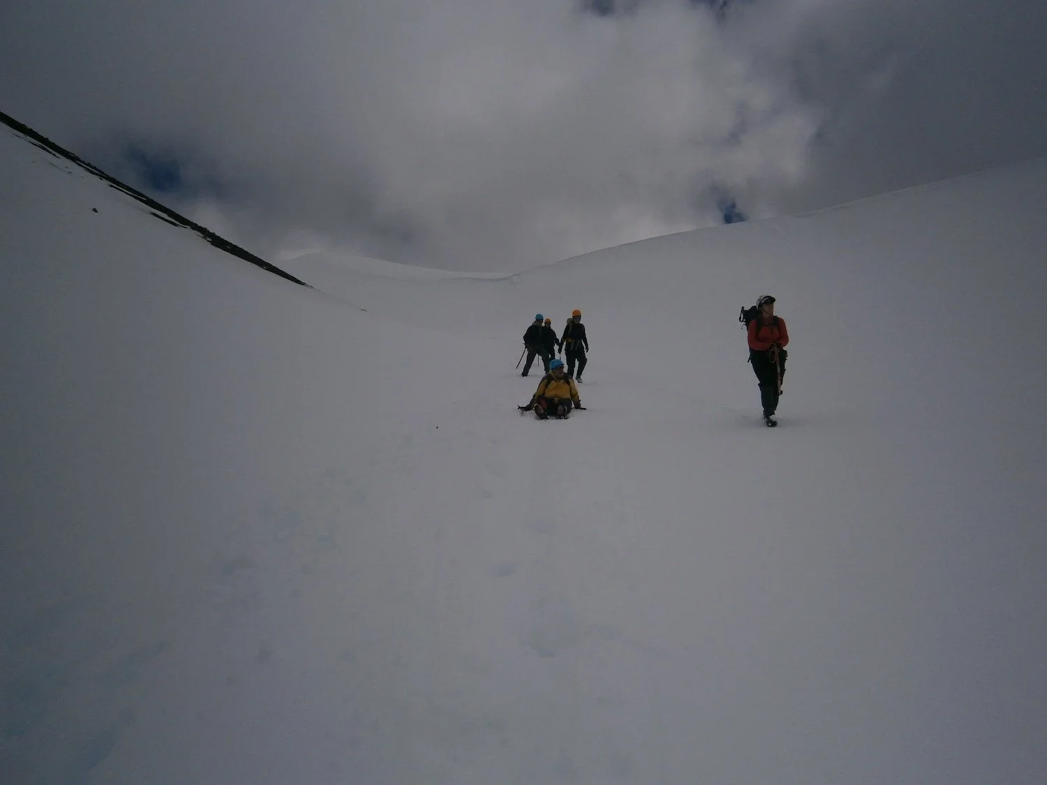 hikers glissading downhill