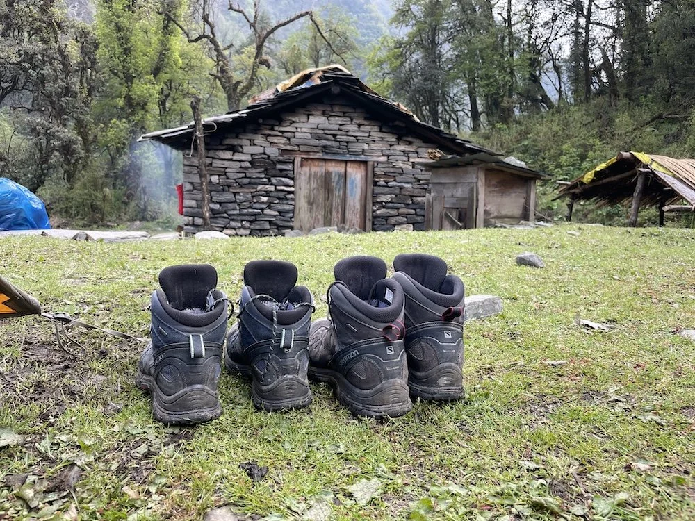2 pairs of trekking boots on the grass in front of a tea house in Nepal