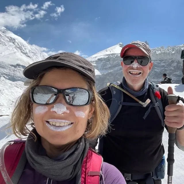 Emma and Trevor with faces covered in zinc sunscreen in the snow