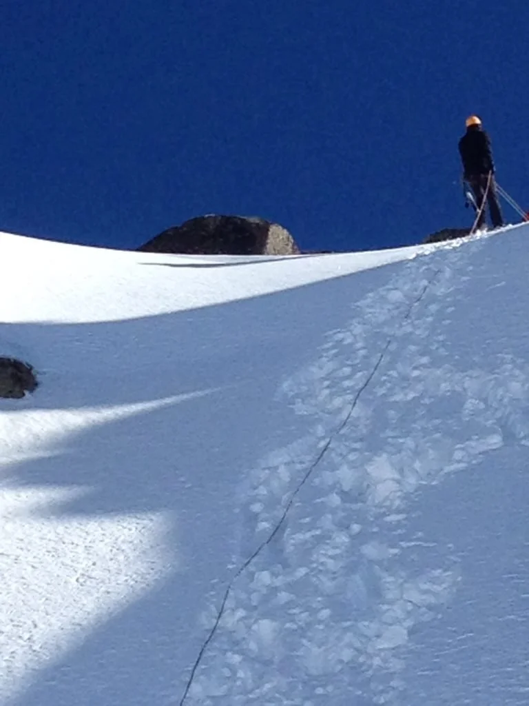 Starting the abseil back down the snow slope