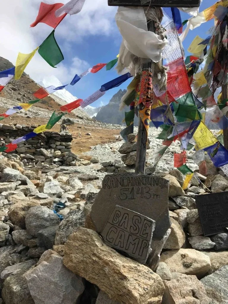 Kanchenjunga North Base Camp prayer flags and rocks marked with the words 'base camp' and the altitude of 5,143m