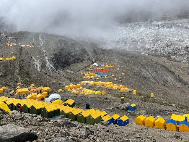 many expedition tents pitched on a glacier