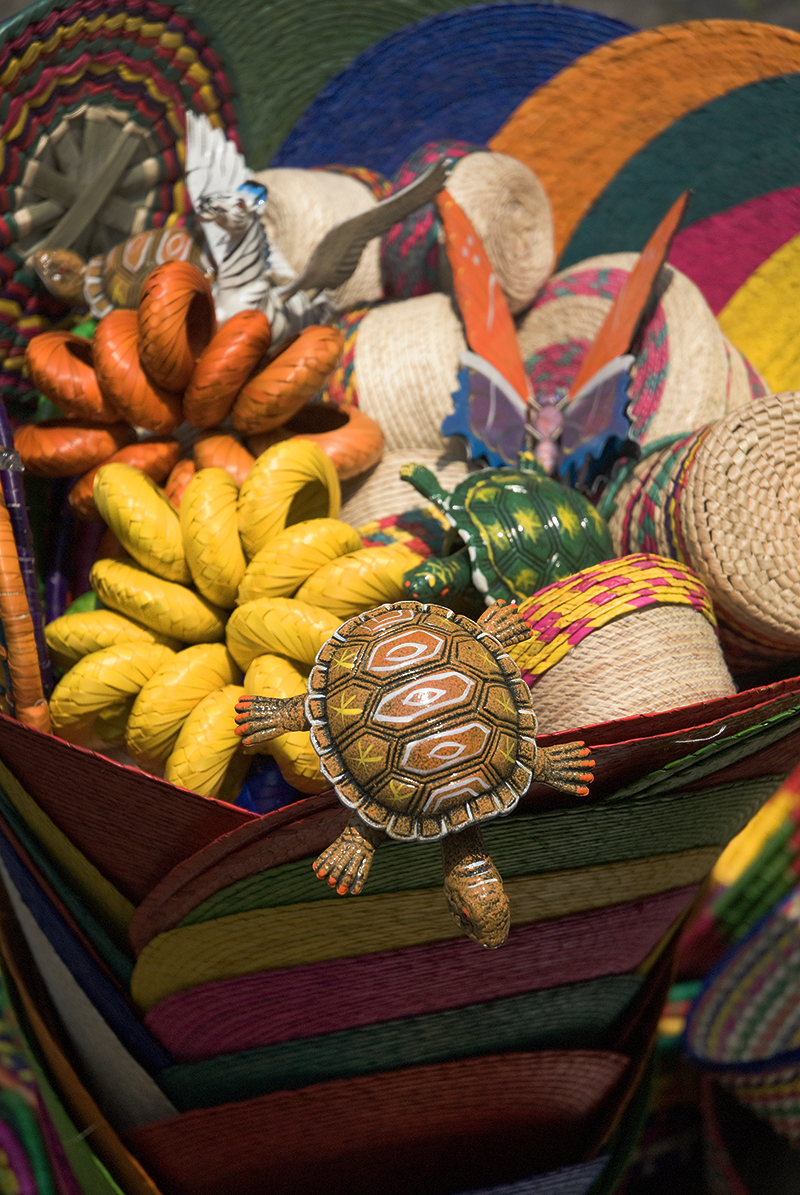 Colorful woven baskets filled with toy animals including turtles, butterflies, a beetle, and a lizard.