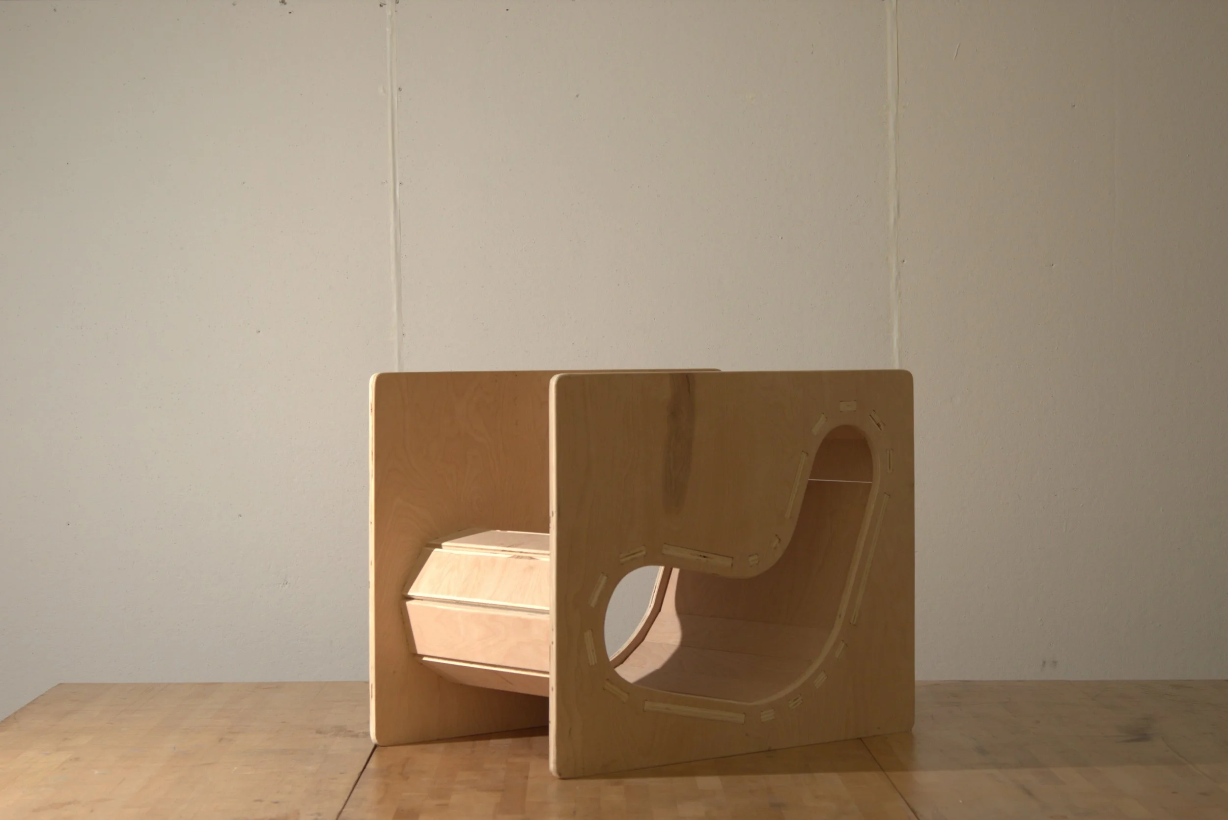 Wooden furniture pieces assembled against a plain wall.