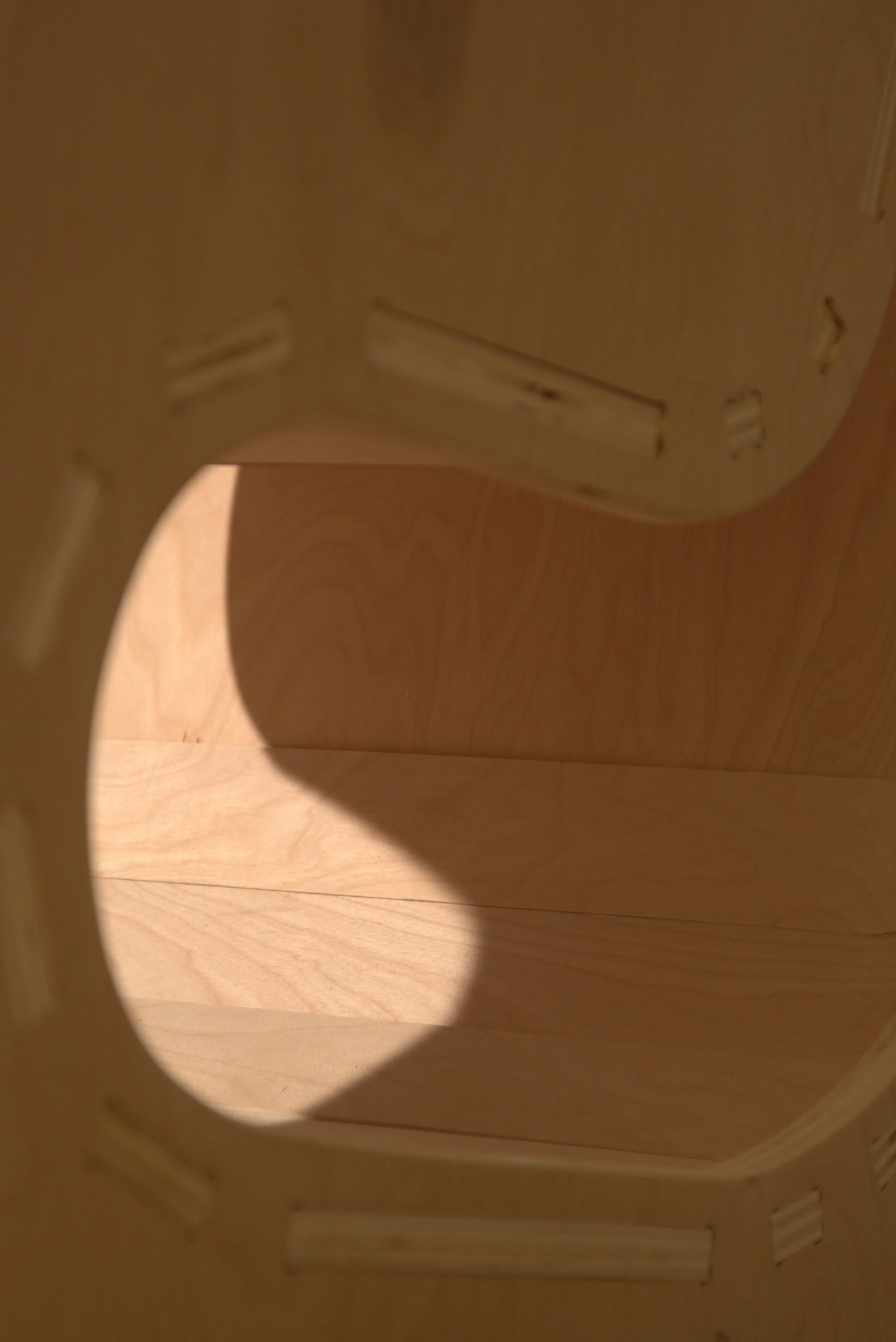 Interior view of a wooden cabinet with multiple doors and shelves, creating a hollow space.
