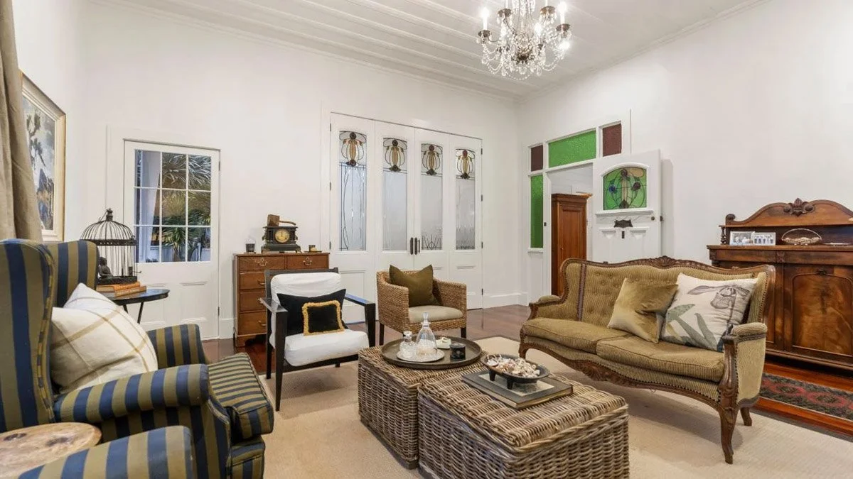 Restored character lounge featuring original detailing, high ceilings and fireplace