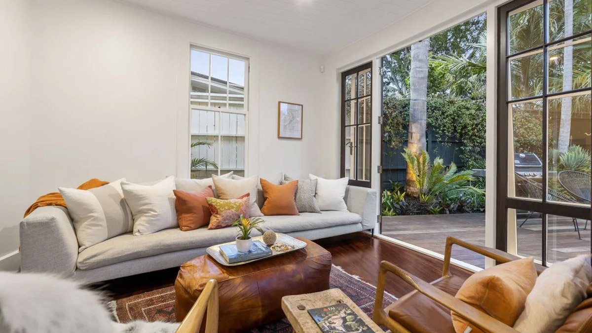 Renovated living room in Devonport character home featuring timber floors, French doors and indoor-outdoor flow