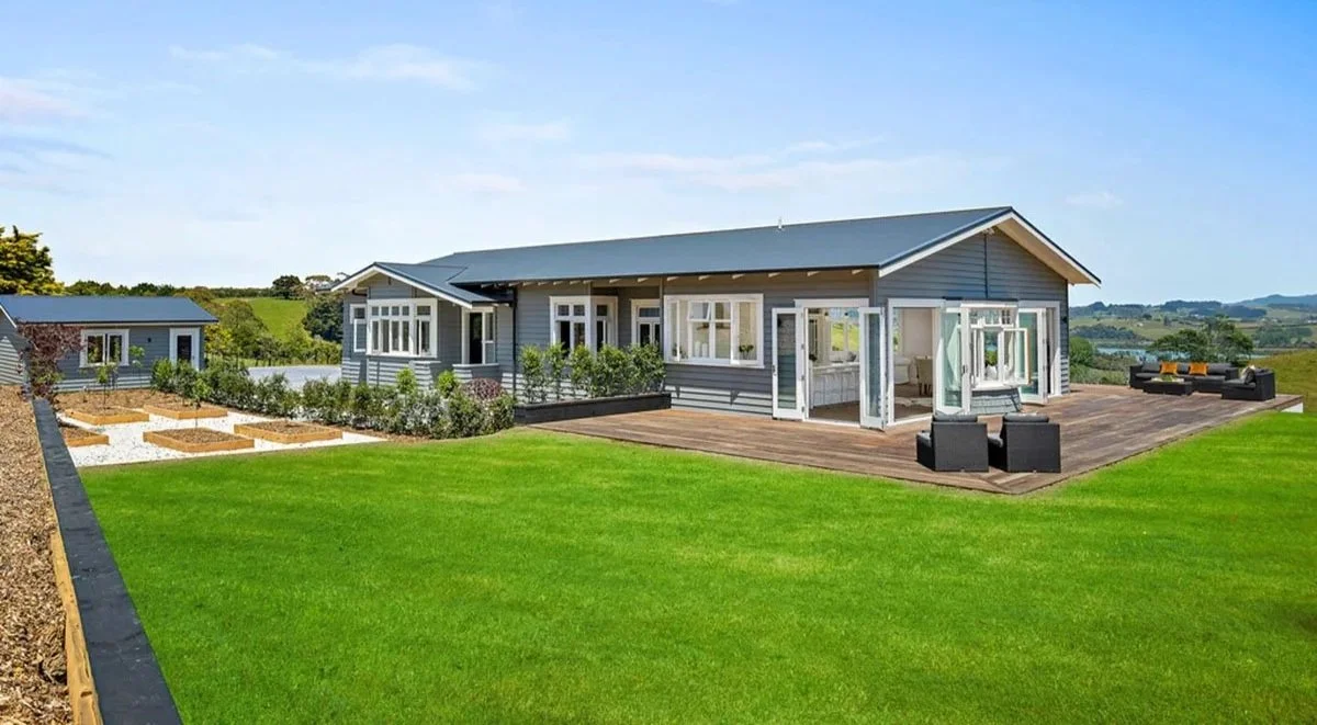 Villa-style bedroom in Tawharanui country home renovation with original character detailing and rural outlook.