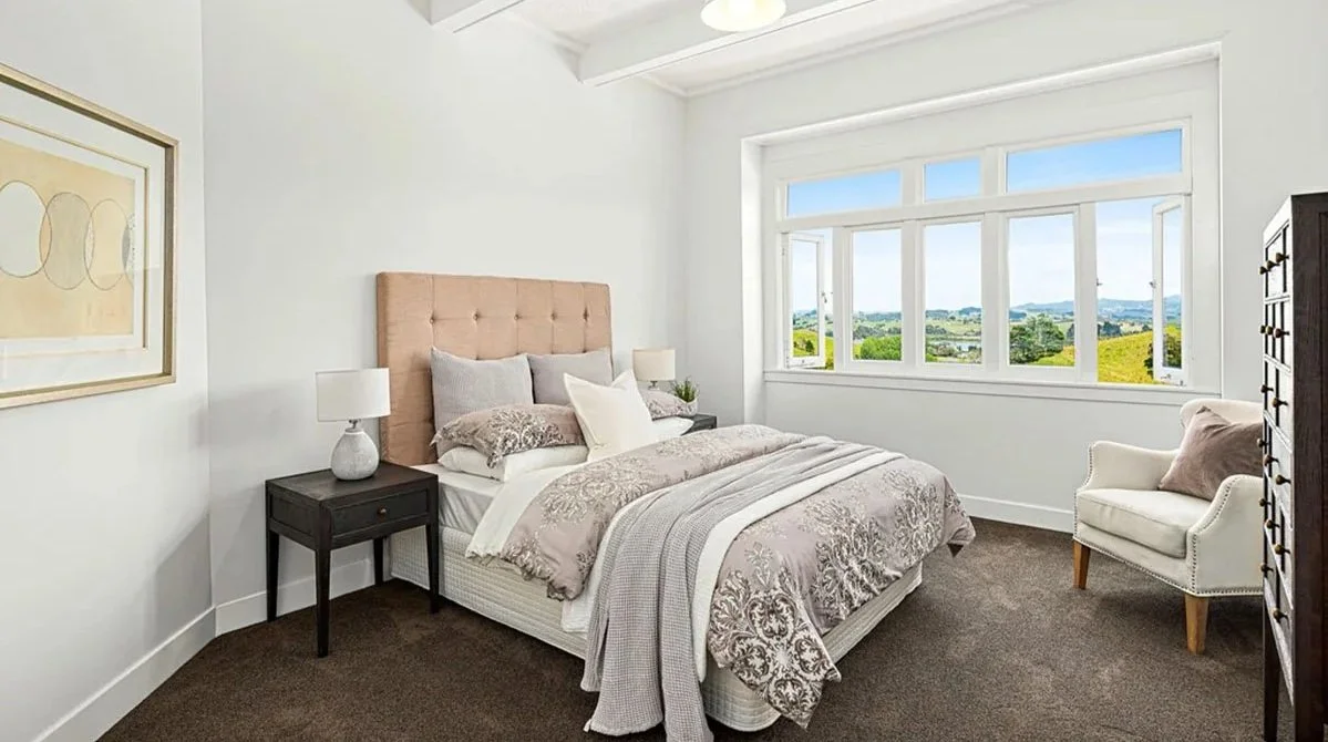 Character bedroom restoration with high ceilings, timber joinery and countryside outlook in a renovated villa-style home.