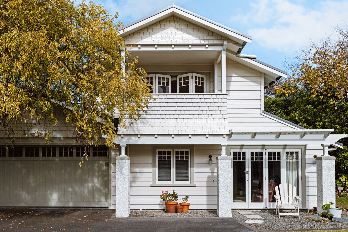 Character home renovation with integrated garage addition and heritage-inspired exterior detailing.