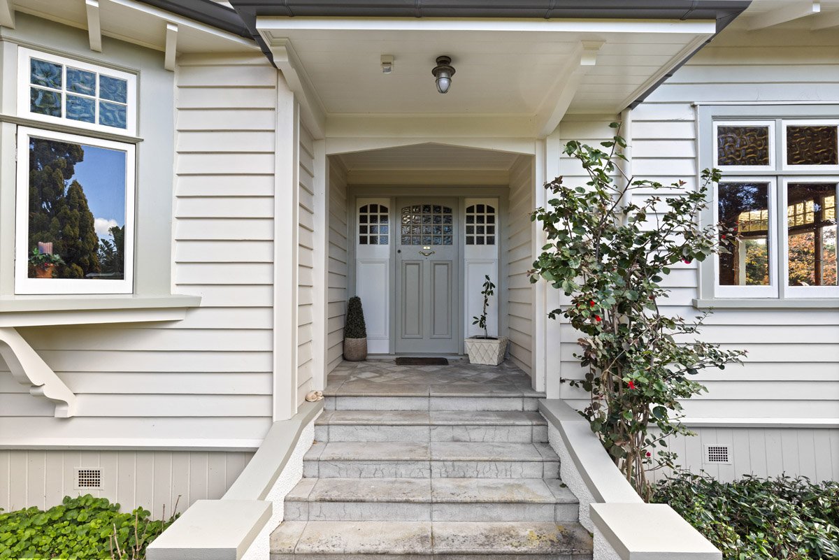 Restored front entrance and tiled staircase of a heritage home renovation project in Auckland.