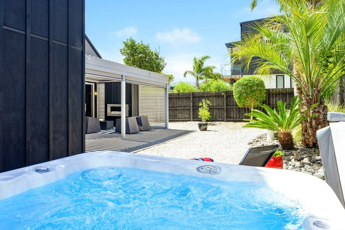 Private courtyard with spa pool and landscaped outdoor living area at an architectural Omaha new build.