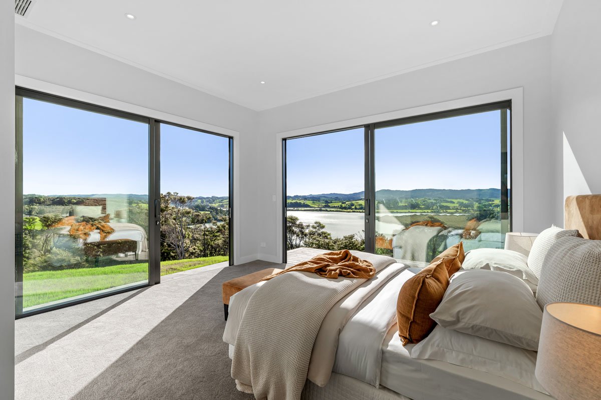 Master suite with panoramic countryside views in Matakana home