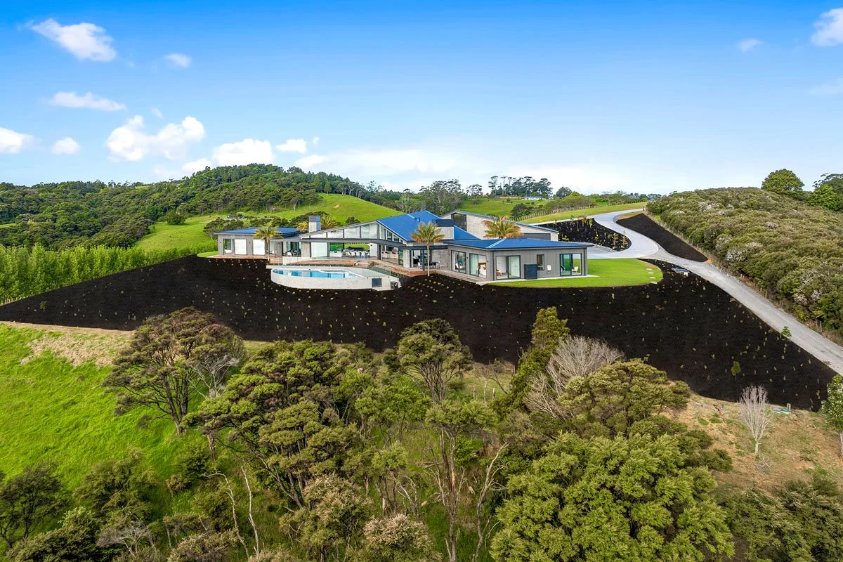 Outdoor living area at Matakana architectural country home and curved pool