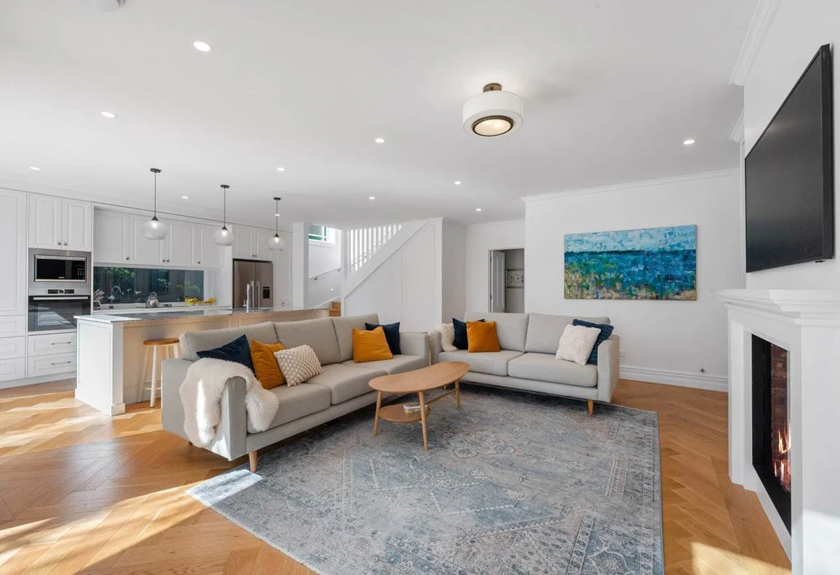 Open-plan kitchen and living area featuring custom joinery, timber flooring and family-focused layout in Devonport.