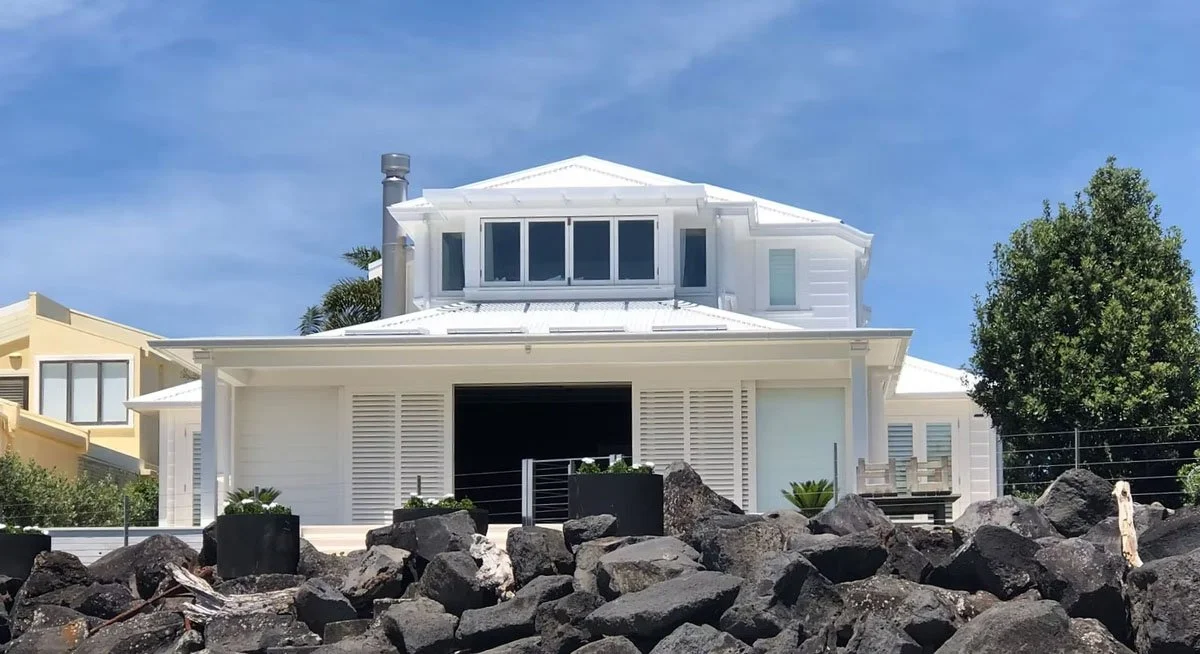 Seaward view of Milford coastal villa extension showing connection to beachfront setting