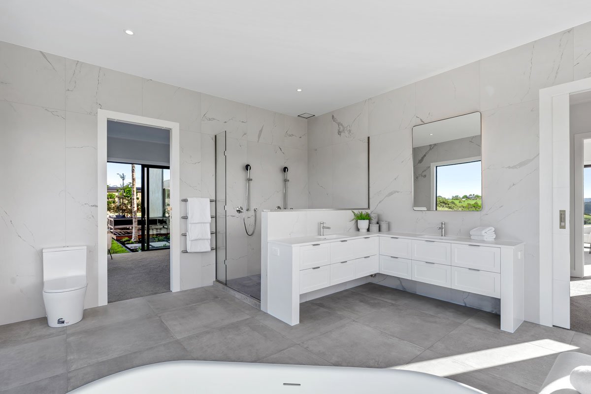 Luxury bathroom with freestanding bath and rural views in Matakana