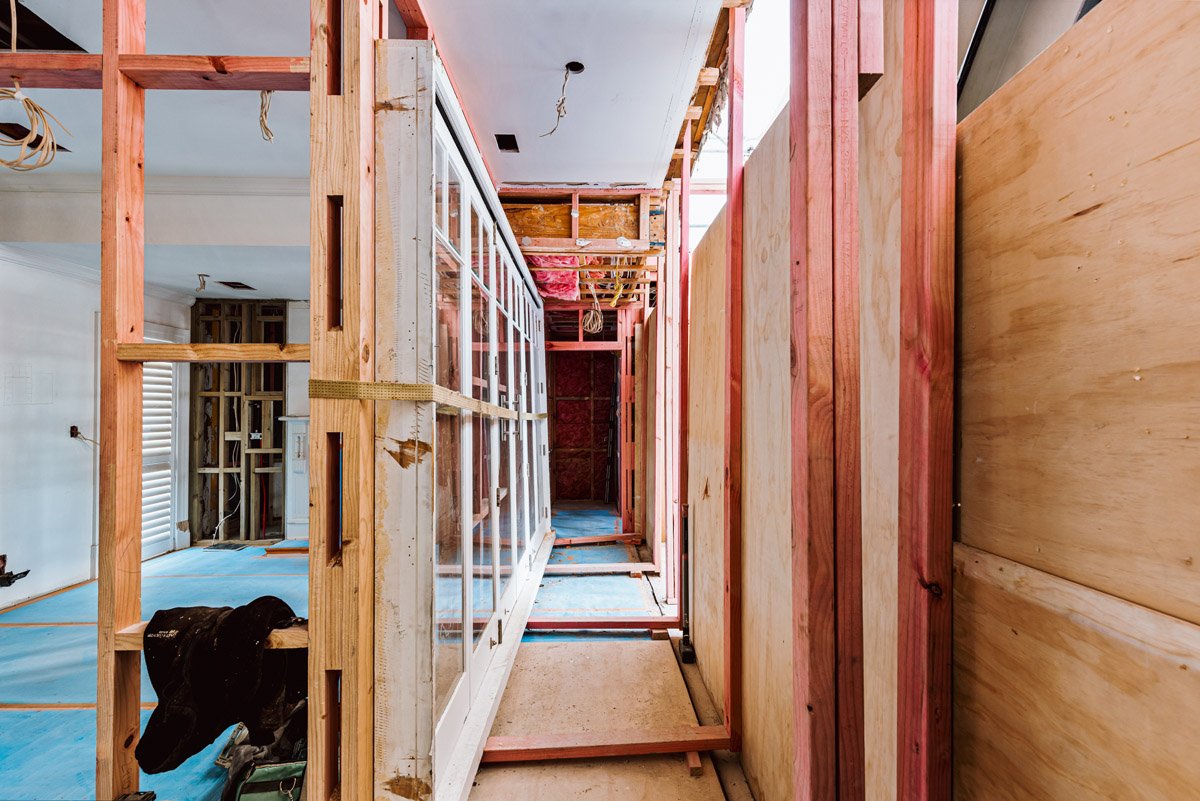 Structural framing and wall reconstruction work underway inside a heritage home renovation project in Auckland by Coast & Country Homes.