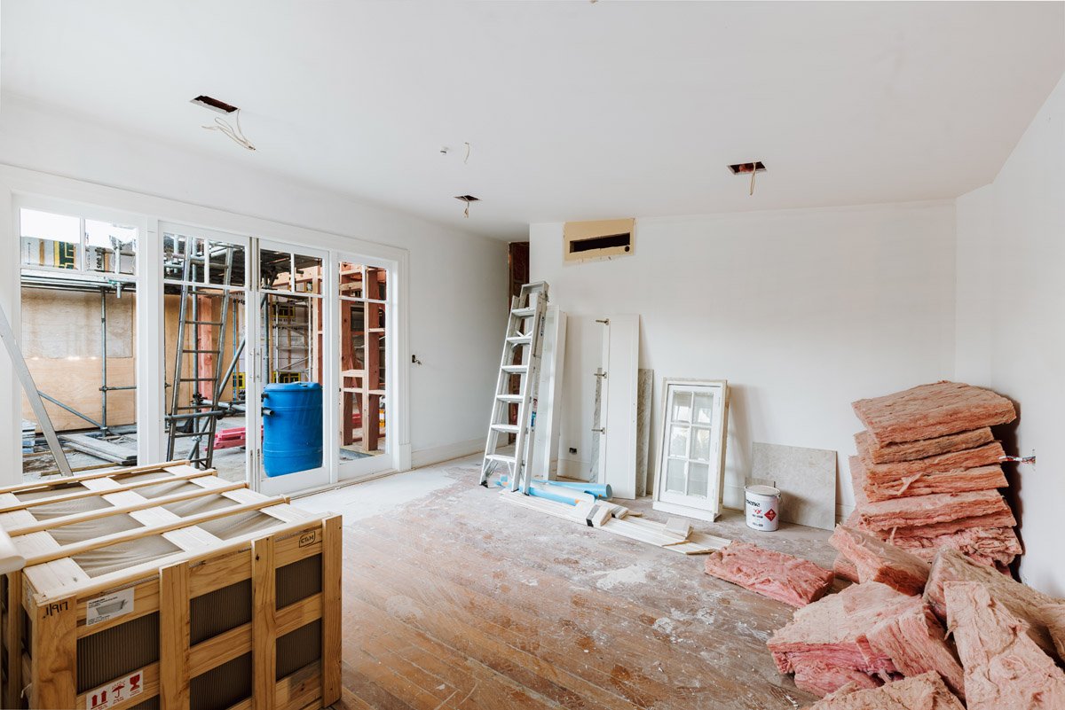 Bedroom renovation nearing completion with fresh plasterboard linings and new joinery installed as part of an Auckland character home renovation.