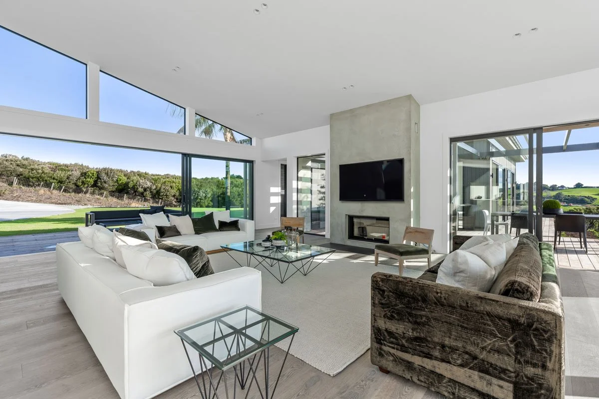 Bedroom with floor to ceiling glazing overlooking Matakana landscape