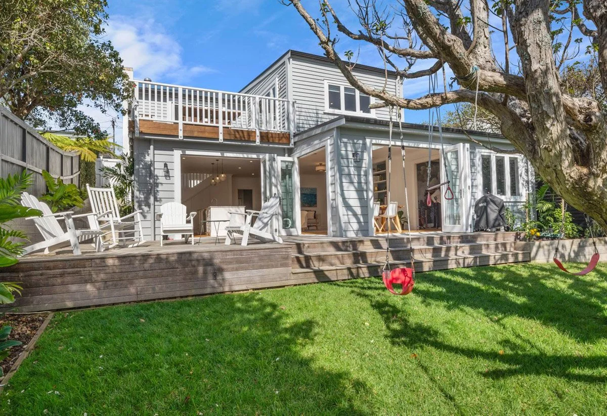Rear exterior of Devonport villa showing basement addition, extensive renovation works, upper-level extension and outdoor living areas.