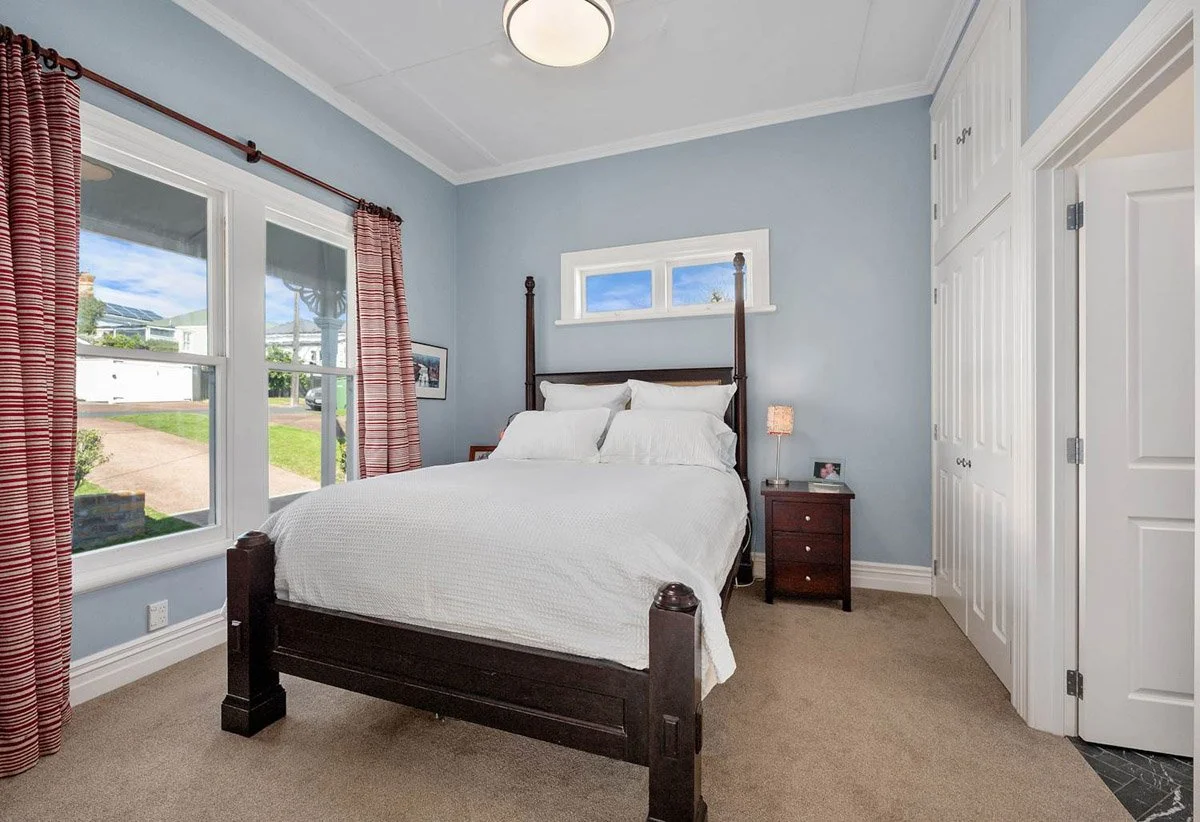 Master bedroom with heritage detailing and modern comforts in extensively renovated Devonport villa.