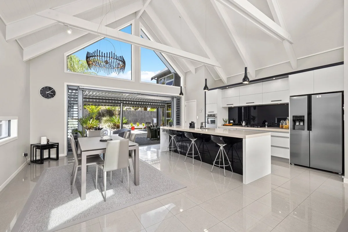 Open-plan kitchen and dining area with vaulted ceilings and seamless indoor outdoor flow in Omaha.