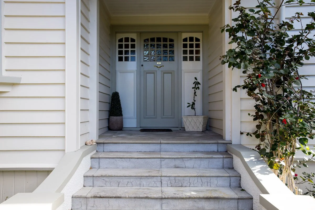 Restored entrance and tiled steps of a renovated character home in Hauraki, Auckland.