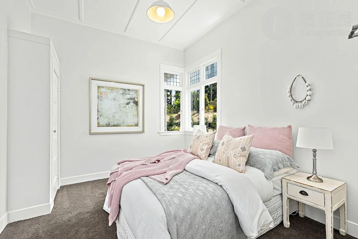 Restored bedroom in Matakana country villa with high ceilings, timber joinery and soft neutral styling.