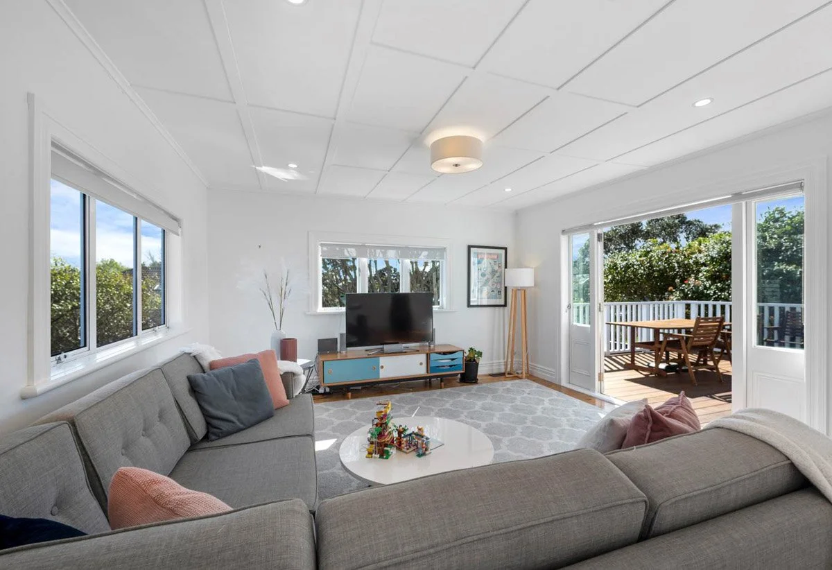 Second living room with outdoor deck access created during staged renovation of Devonport character home.