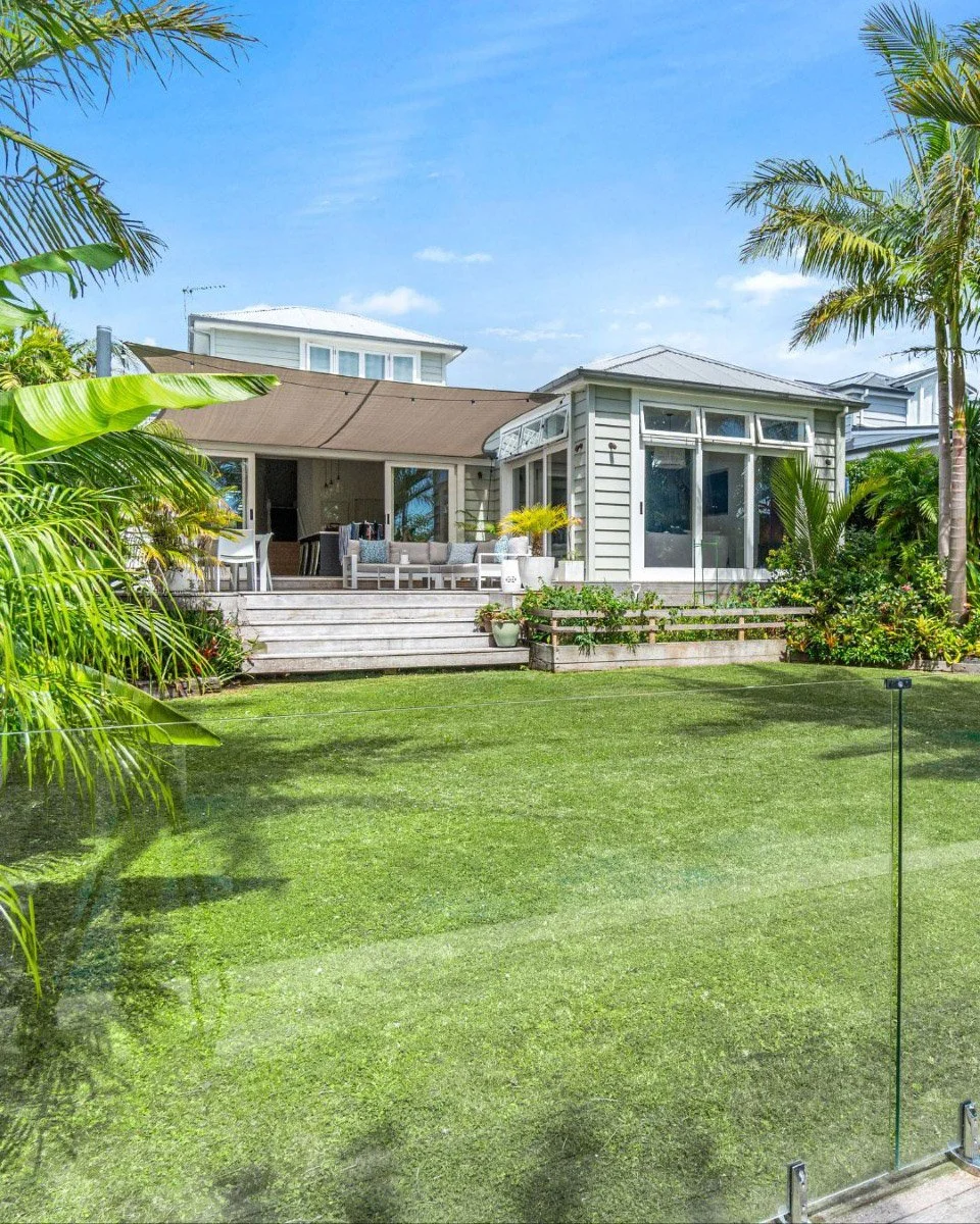 Home addition and outdoor entertaining area overlooking landscaped gardens and swimming pool in Stanley Point.