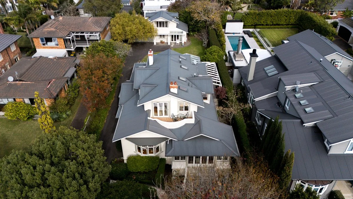 Elevated aerial view of a renovated heritage home and landscaped site in Hauraki on Auckland's North Shore.
