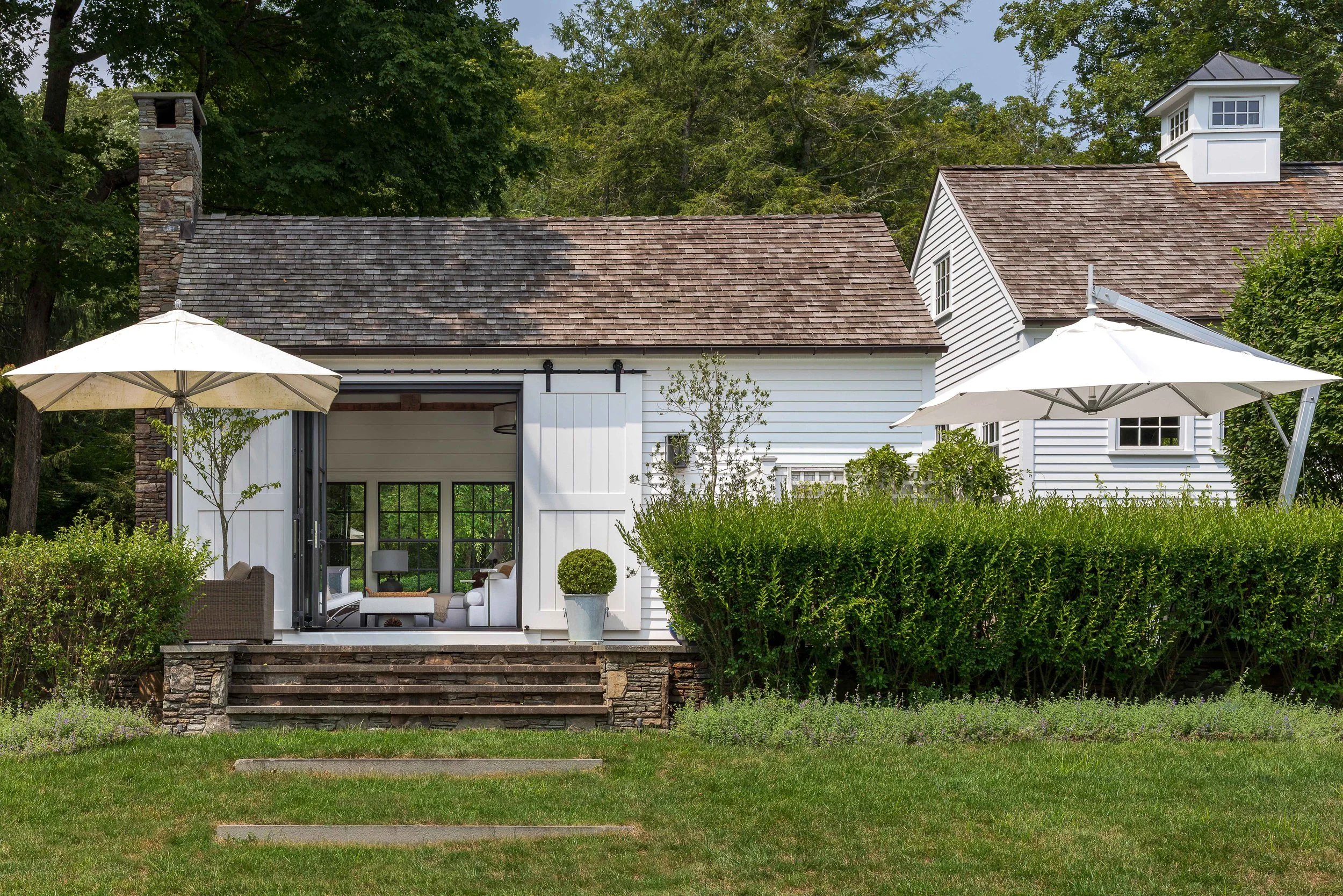 04-pool-house-exterior-barn-doors-open-patio-view.jpg