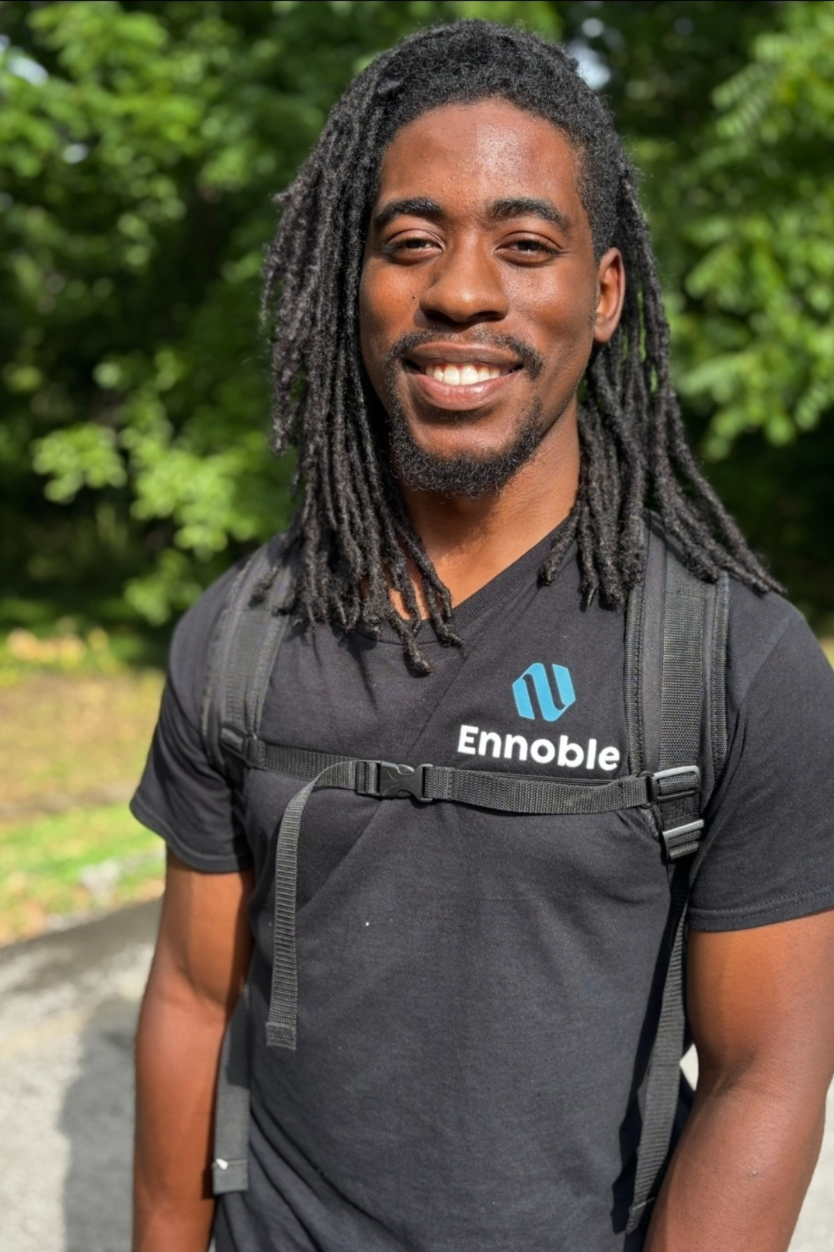 photo of Joshua Perry with Ennoble Smart Home & Home Cinema wearing a Ennoble Smart Home uniform, smiling with a backpack tool bag