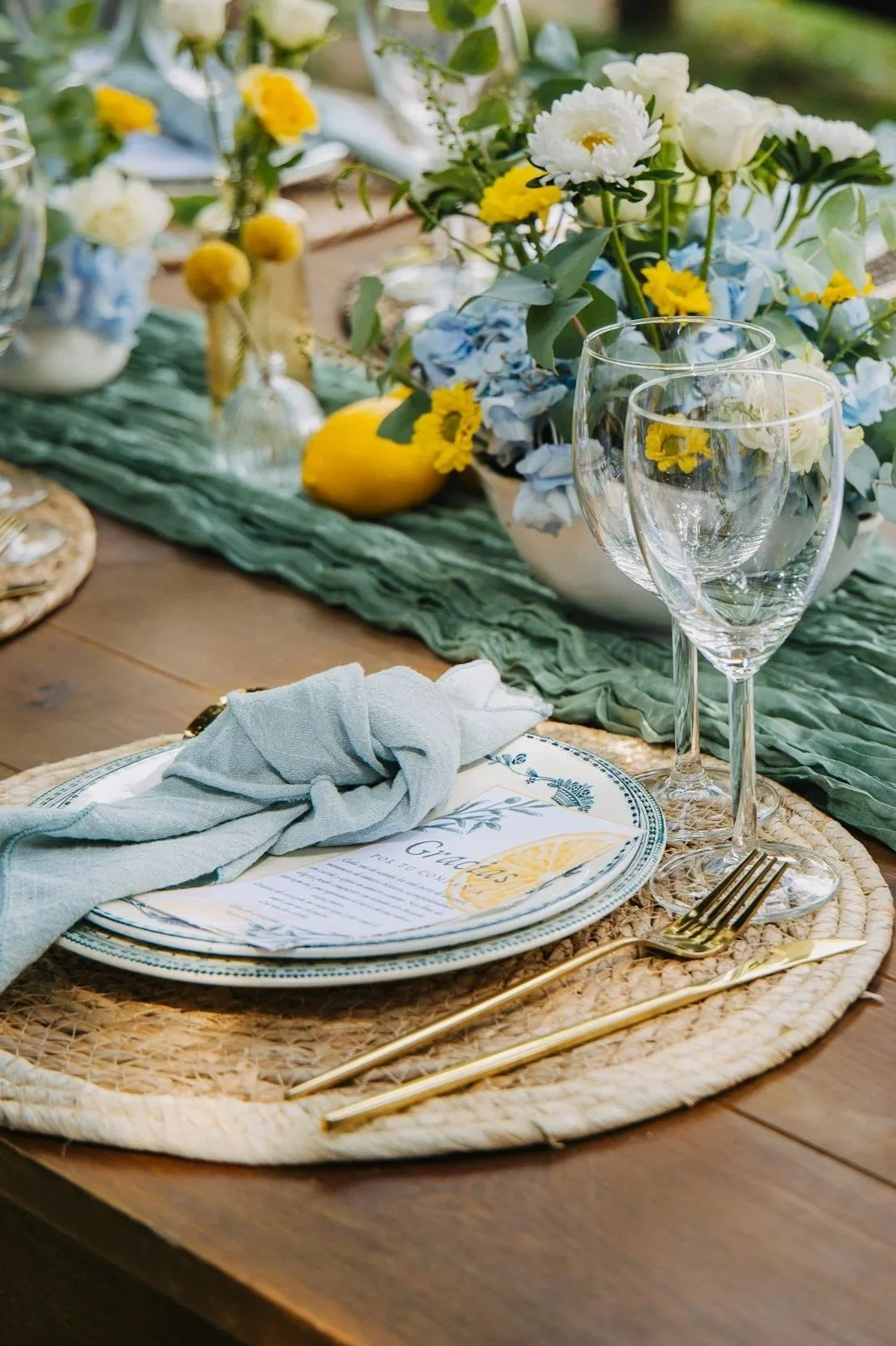 Elegant table placements for event with white blue and yellow flowers