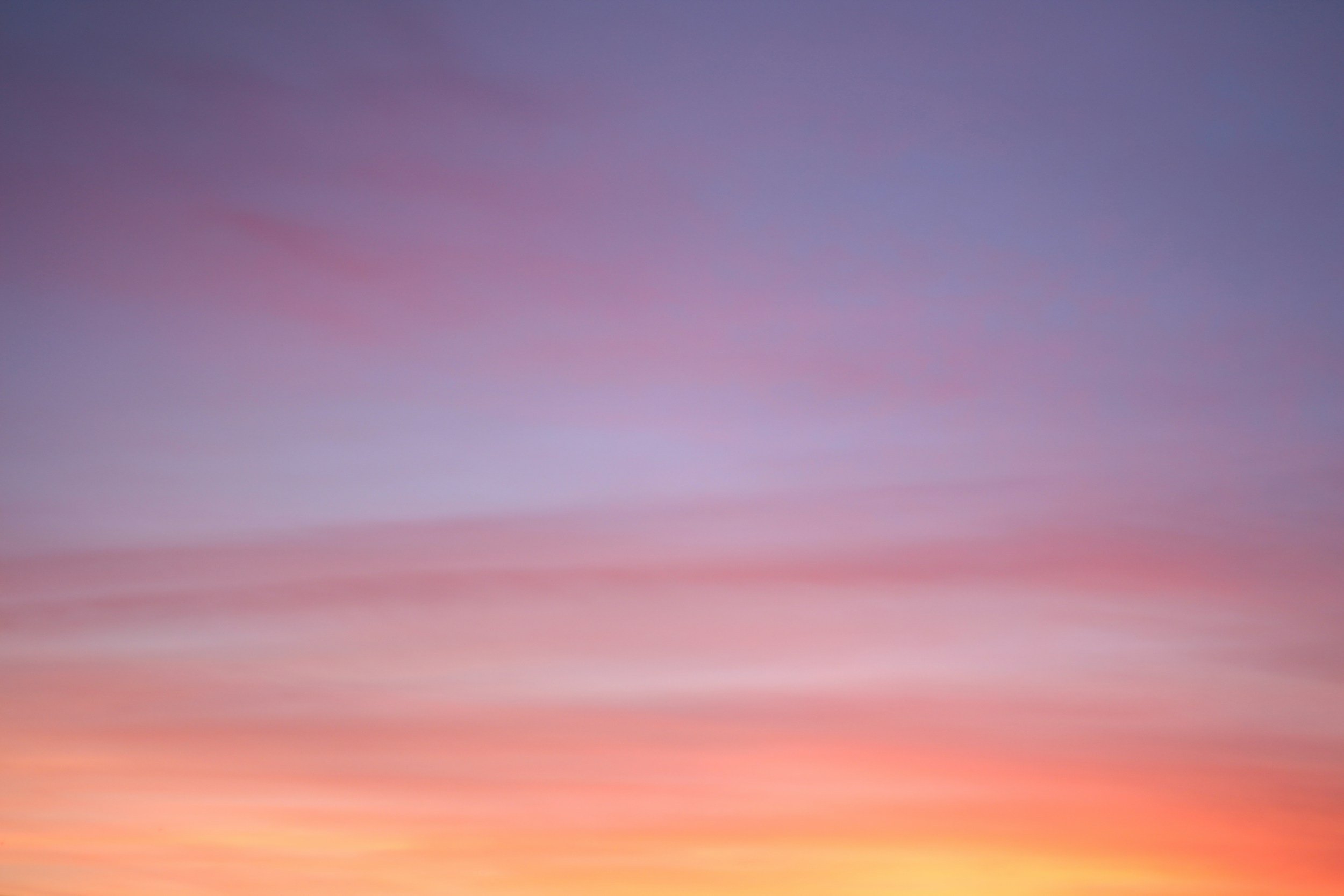 A colorful sky during sunset with shades of purple, pink, orange, and blue.