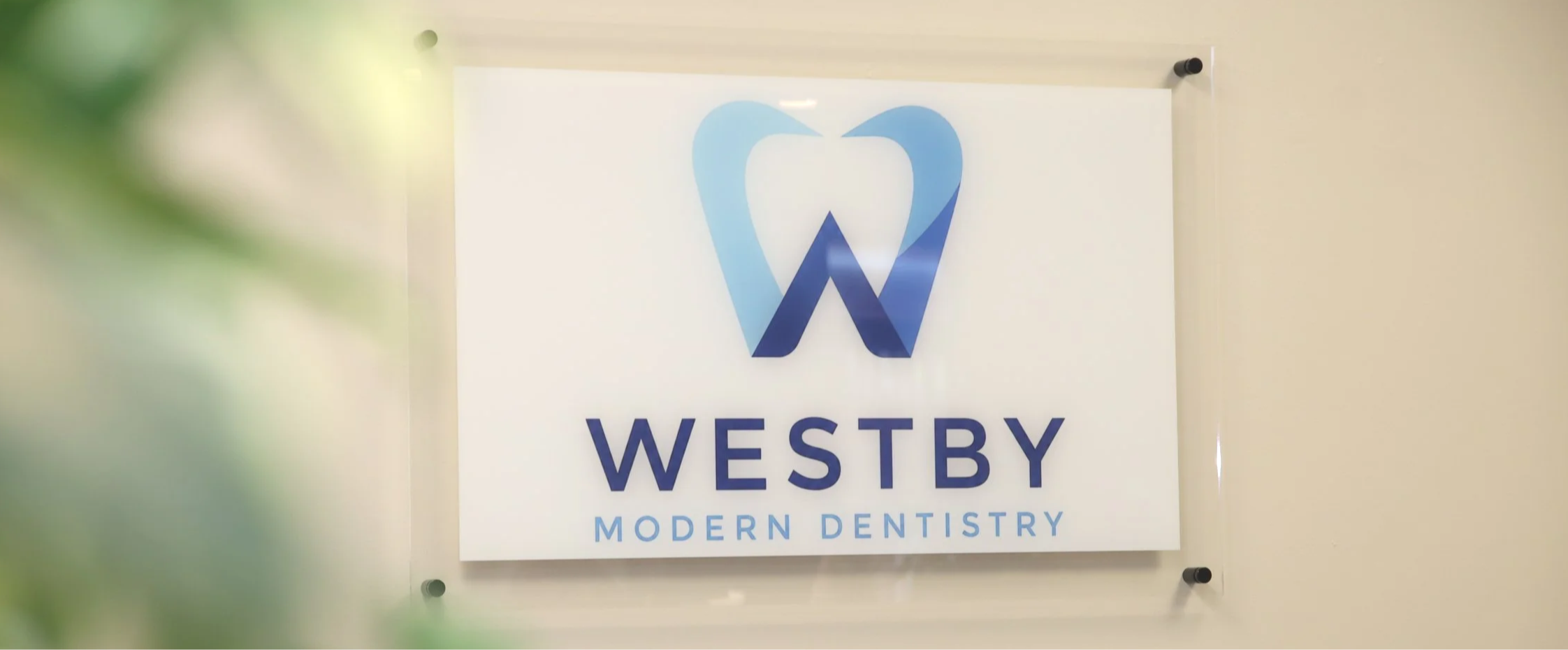 Sign for Westby Modern Dentistry featuring a blue tooth icon and the clinic's name.