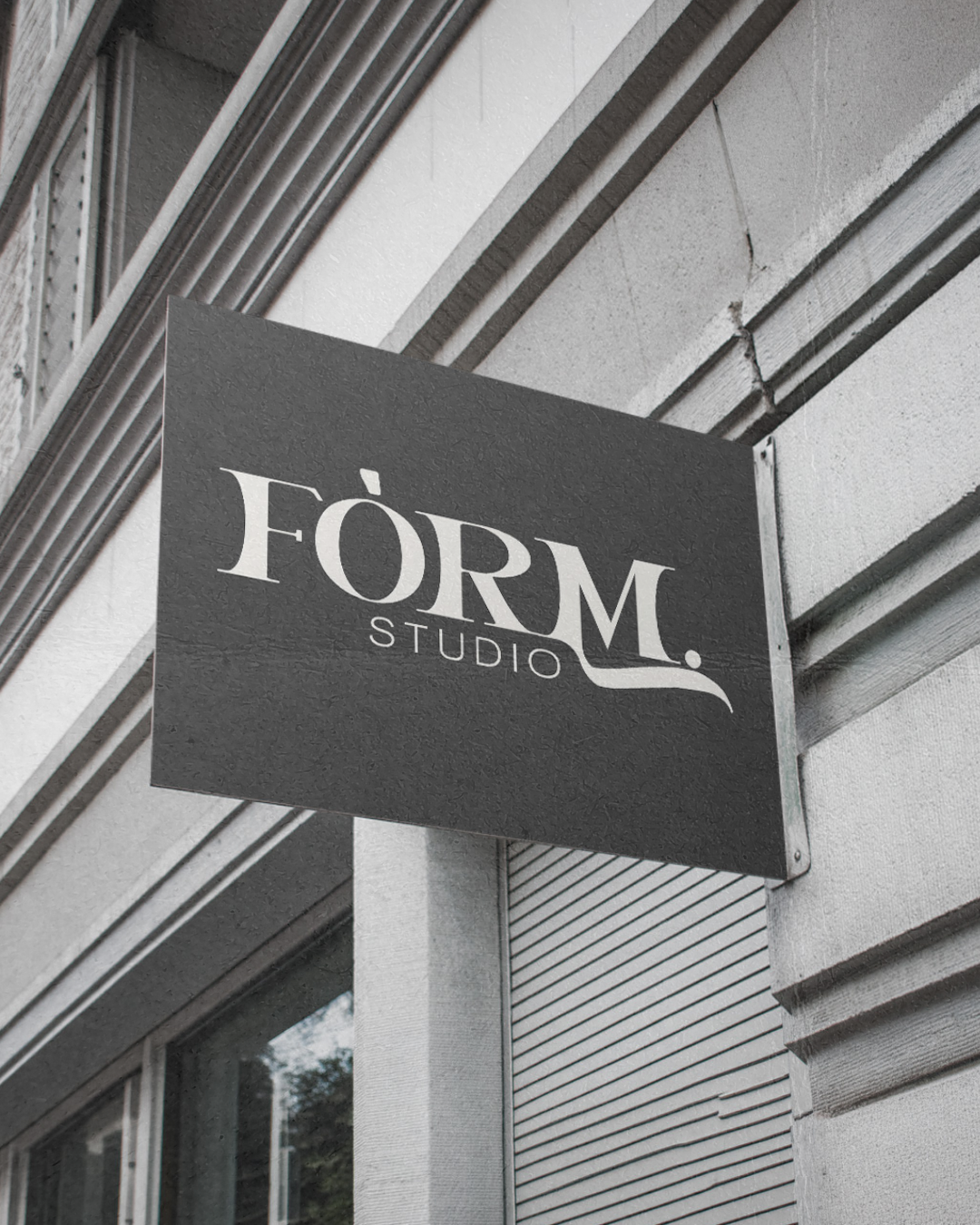 A black rectangular sign with the text 'FORM. STUDIO' mounted on a building's exterior wall.