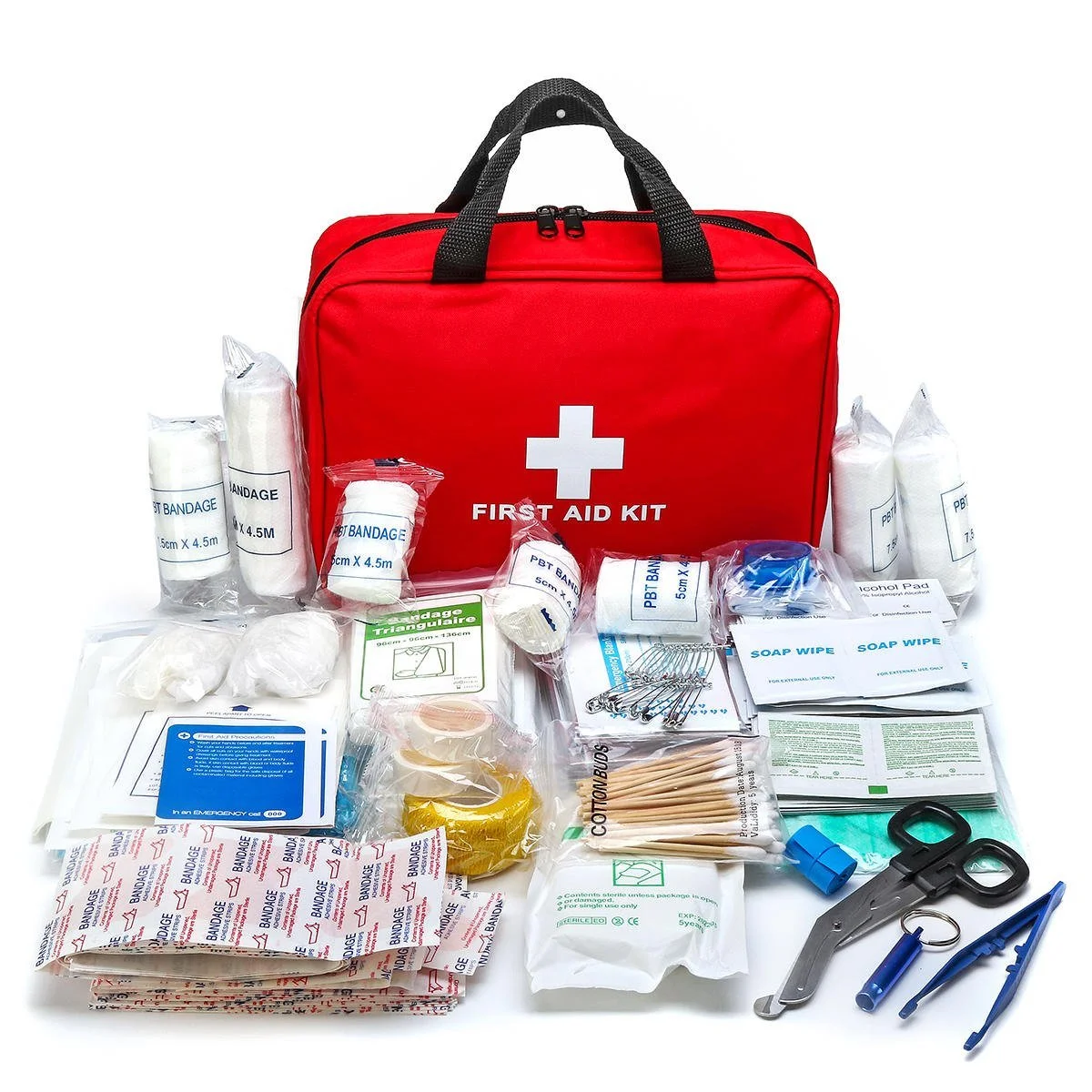 A red first aid kit bag surrounded by various medical supplies including bandages, antiseptic wipes, scissors, tweezers, cotton swabs, adhesive tape, gauze, alcohol pads, and safety pins, all laid out on a white surface.